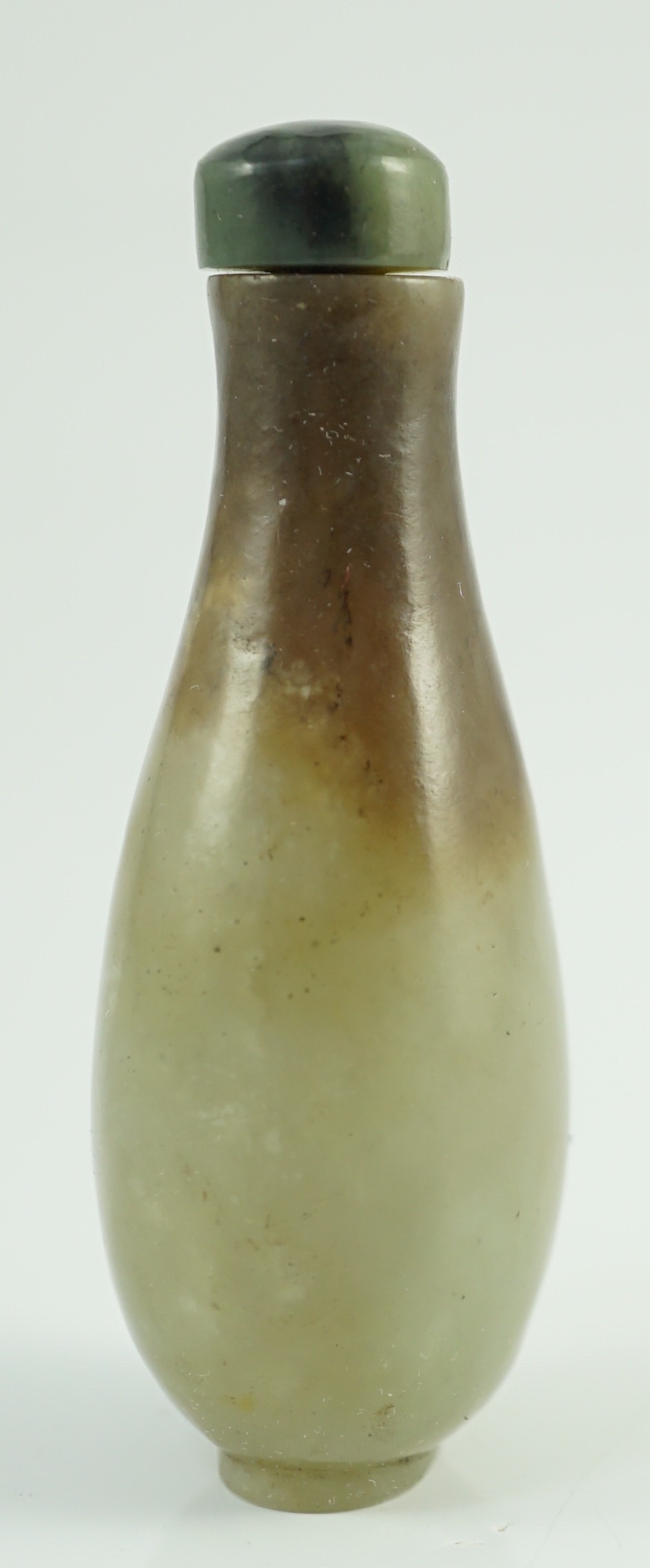 A Chinese celadon and brown jade pear form snuff bottle, 19th century, 7.2cm high